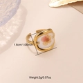 Detailed macro of gold open ring featuring preserved orange flower in square setting - Gold - Square Pink & Orange Flower