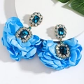 Detailed view of oversized blue fabric flower earrings with a large center gemstone - Style 7 (Blue Pendant)