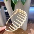 Detailed view of beige matte wide headband with inner teeth for volume and grip - Cream