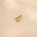 Gold plated letter D pendant with micro-paved zircons on champagne silk fabric - Letter D / Gold