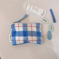 Blue plaid fabric coin pouch shown with cosmetic items on a neutral background - Blue and White Large Grid with Red Line
