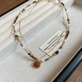 Detail of 18K gold plated tiger eye necklace with double-layer beads on jewelry tray - Goldstone Round Pendant Style / Gold-Coffee-Orange-Real Gold Plated