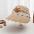 Detail of khaki sun visor for kids with bear patch and capibara text on a white stand - 52-54cm (3-8 Years) / Khaki