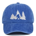 Detailed close-up of Bigfoot and pine forest embroidery on washed cotton baseball cap - Sapphire Blue