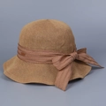 Detailed close-up of woven straw sun hat with elegant ribbon bow and textured wide brim - M (56-58cm) / Camel