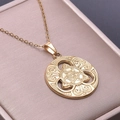Detailed macro view of a 18k gold plated stainless steel Celtic knot pendant in a gift box - Gold Color Necklace With Pendant