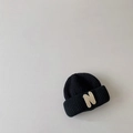 Close-up of black knit beanie for kids showing detailed texture and N letter patch detail - Black