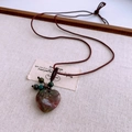 Detail of heart-shaped natural stone pendant with braided rope and decorative beads - Red and Green Ore Heart Pendant (WN1478) / Colorful