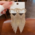 Macro shot of silver needle tassel earrings with heart-shaped sparkling rhinestones - Golden Pave Heart Tassel (45# Silver Earring Post-Gold Heart)