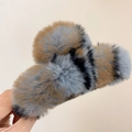 Close-up of fluffy grey and brown striped rabbit fur hair claw clip held in hand - Small (13cm) / Blue-Grey Leopard