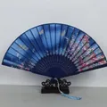 Blue Japanese folding fan with silver butterfly patterns and a light blue tassel - Dark Blue Silver Butterfly Pink Flower (Style 44)