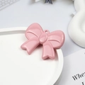 Macro shot of pink acrylic bow pendant with hanging hole for DIY jewelry making - Pink