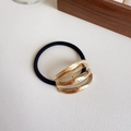 Elastic black hair tie featuring a layered gold metallic oval geometric buckle accessory - Triple Row Rose Gold