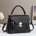 Detail of black lychee grain PU leather handbag with gold hardware and dual zippers - Black