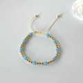 Detail of adjustable light blue frosted cube beads and polished gold beads on string - Light Blue