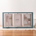 Detail of teal triple rotating 4x6 wood picture frame displayed on lace tablecloth - Triple Blue / 6 Inch