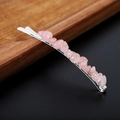 Macro detail of natural pink crystal stones on a silver metal hairpin with wood decor - Rose Quartz with Silver Clip