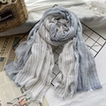 Artistic blue and white striped cotton linen scarf with tassel edges on a vintage display - Sky Blue