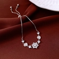 Macro shot of silver zircon flower pendant and adjustable slider clasp detail on bracelet - Silver-White