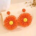 Vibrant orange handmade woven raffia flower drop earrings for a summer vacation look - Orange