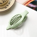 Matte light green oval hair claw clip for women in a minimalist elegant scene - Matte Fruit Green