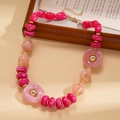 Detail of pink and peach resin beads with gold metal spacers on a vintage sweater necklace - Necklace / Pink