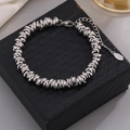 Hip hop style titanium steel bracelet with twisted links and S.Steel tag on black jewelry box - Adjustable Size / Steel