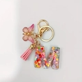 Pink resin alphabet letter M keychain with heart sequins, butterfly and tassel - Letter M