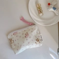 Close-up of cute puppy and floral print on cream cotton mini zipper pouch for small items - Pink Floral Puppy
