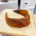 Detail view of a handmade caramel brown knotted headband with textured fabric finish - Brown
