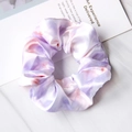 Detailed view of a purple and white tie-dye satin scrunchie with a silky texture finish - Tie Dye Purple