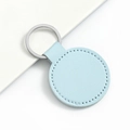 Minimalist light blue leather car keychain with silver metal ring on neutral background - Round / Light Blue