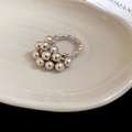Detail of silver beaded cluster ring with textured band on a ceramic plate - Silver