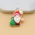 Detailed close-up of a colorful resin Santa Claus charm with a green gift bag and metal ring - Santa Carrying Gift with Pin