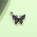 Detailed macro view of silver butterfly pendant with black rhinestones and alloy metal finish - Black Butterfly UV Silver Plated