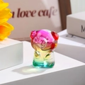Close-up of rainbow gradient glass pig figurine on a modern white display stand - Zodiac Pig / Rainbow Gradient