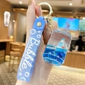 Blue liquid keychain featuring a miniature ship and bubble wrist strap with gold ring - Sapphire Blue Sailboat - Can