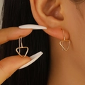 Minimalist gold geometric triangle drop earrings worn on ear for size reference - Inverted Triangle Style (3588) / Gold