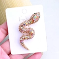Snake brooch with champagne rhinestones on gold base shown on fashion card display - Champagne
