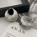 Irregular silver textured hoop earrings with a layered wave design and brushed finish - Silver