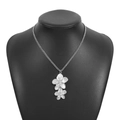 Detail of silver double layered flower pendant on black mannequin with fine chain - Silver Double Flower Necklace (N12172)
