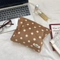 Close-up of brown corduroy polka dot makeup bag with a minimalist brand label - Brown Polka Dot / Khaki