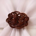 Dark brown rattan napkin ring featuring a Celtic knot design on white fabric - Celtic Knot