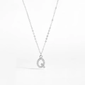 Macro shot of silver letter Q pendant with sparkling cubic zirconia on a delicate chain - 925 Silver / Letter Q