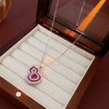 Close-up of a silver gourd pendant with rose red gems in a wooden jewelry box - Necklace-Silver Purple