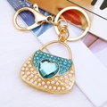 Golden handbag keychain with white pearls, blue rhinestones and a heart crystal - Blue Pearl Heart Handbag Keychain