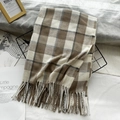 Plaid cashmere-like scarf in brown and beige tones with fringes on a decorative basket - Beige Khaki