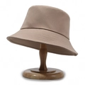 Minimalist khaki cotton bucket hat with precision stitching on a wooden display stand - One Size / Deep Beige