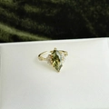 Macro view of gold-plated ring with olive green marquise zircon and side accents - Gold Marquise Green Zirconia Open Ring