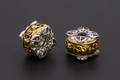 Macro view of retro skull and cross patterns on gold-silver tone metal spacer beads - Skull / 11x11mm